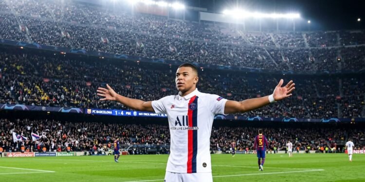 Kylian Mbappé in PSG white away jersey celebrating a hat-trick goal at Camp Nou stadi
